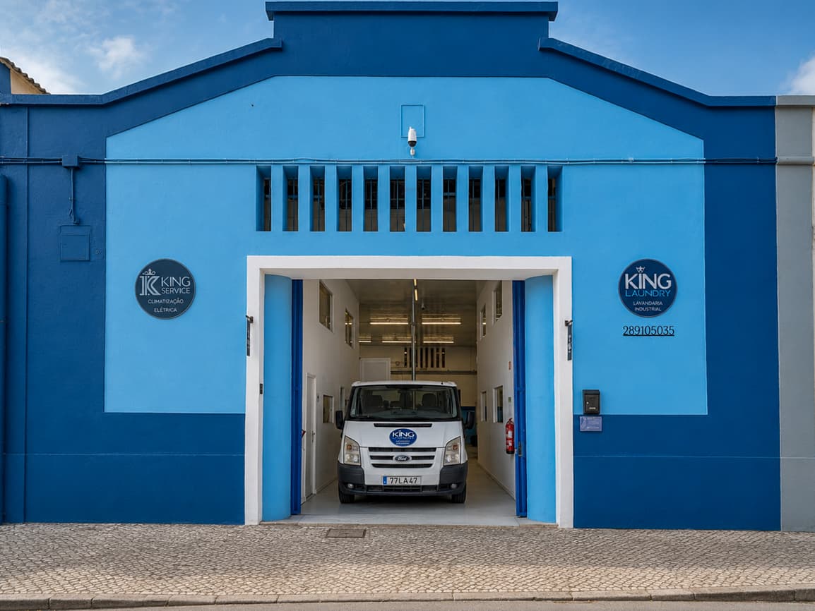 The blue façade of the Loulé plant, with the collection van parked in the doorway.